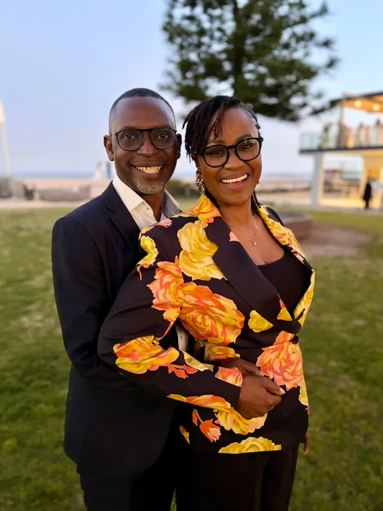 Dr Michaels Aibangbee and Pastor Osas Michaels-Aibangbee smiling together outdoors at dusk
